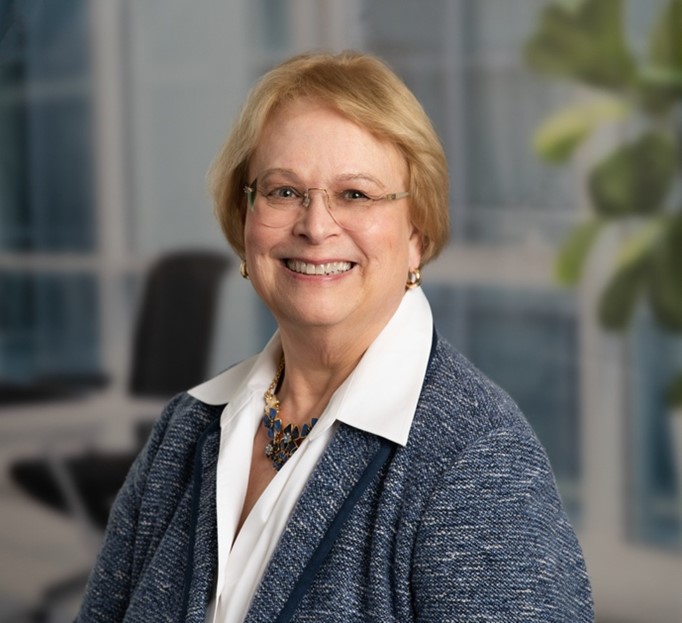 Portrait of Sharon Hull wearing a white shirt and blue cardigan.
